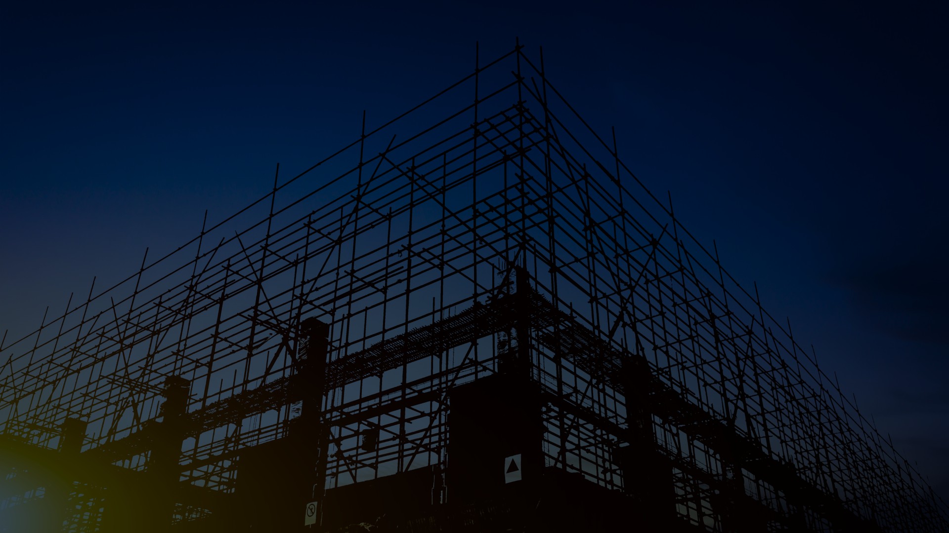Active construction site with scaffolding and site management systems